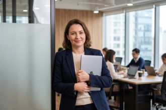Femme d'une quarantaine souriante dans un espace de coworking moderne